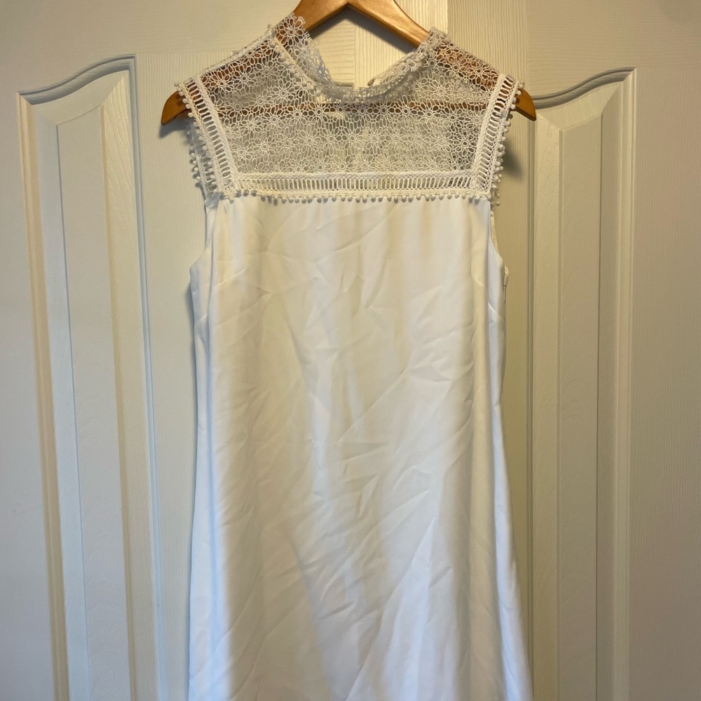 Cut in a timelessly elegant A-line silhouette, this dress with sheer lace panel